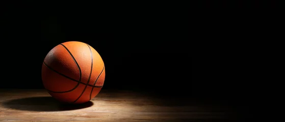  Ball for playing basketball on dark background with space for text © Pixel-Shot