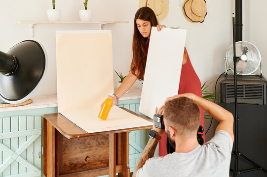 Photographer shooting with an assistant