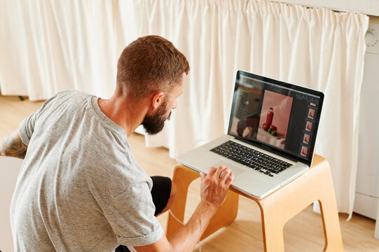 Photographer using a laptop for a shoot