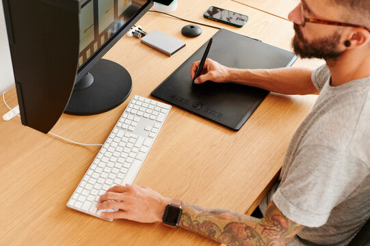 Photographer using a computer and tablet