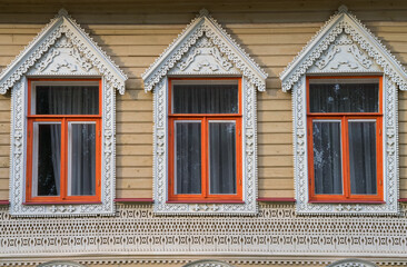 Detail of old wooden house with turrets in Votkinsk (Udmurtia, Russia). Close-up of windows