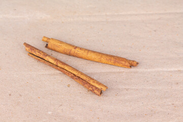 cinnamon on brown paper background front view close up.