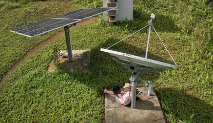 Telecommuter, digital nomad or remote worker under satellite dish wifi