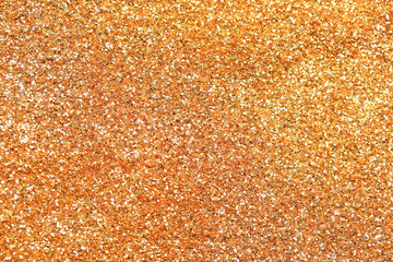 Beautiful golden shiny glitter as background, top view