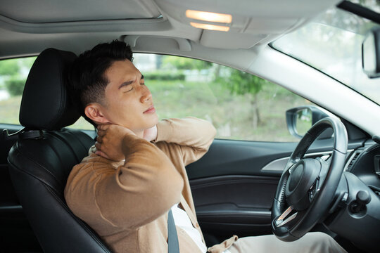A car driver with muscle pain