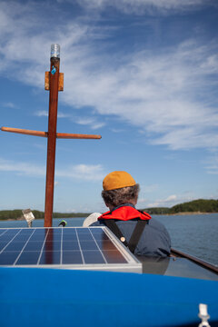 Back view of senior man on small boat