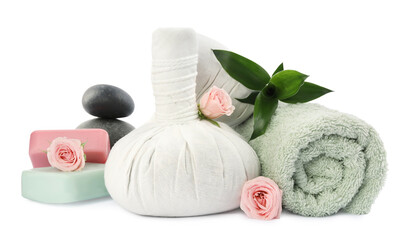 Obraz na płótnie Canvas Herbal massage bags, soap, towel and spa stones on white background