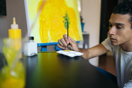 Young Artist Painting Some Details Of His Abstract Work