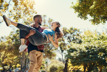 Young interracial couple, park and man carrying woman on summer date in garden, sunshine fun or...