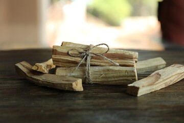 Palo santo sticks on wooden table, closeup