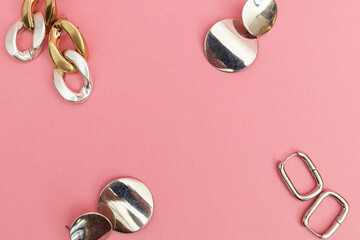 Silver jewelry on a pink background