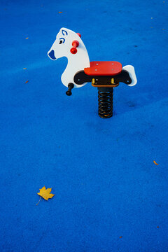 A toy horse on the playground.