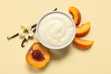 Bowl of tasty pudding with vanilla sticks and peach on beige background