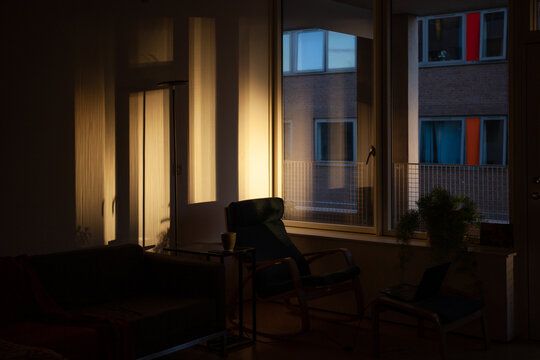 Sunset throws light through windows across the walls of apartment