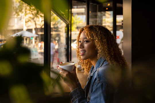 Smiling woman with cup of coffee