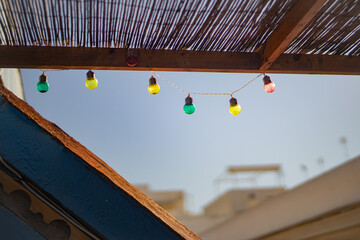 Colored twinkling lights hanging from a terrace
