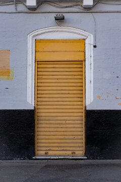 Typical facade of a  shop shutter  in Cadiz, Spain