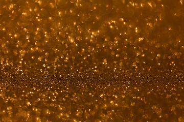 Golden glittering background for design and free space.