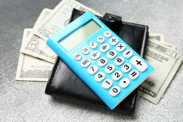 Calculator and wallet with money on white background. Budget concept