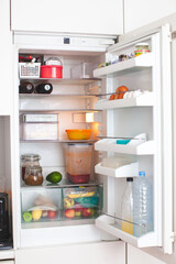 Open fridge in the kitchen. House organization. 