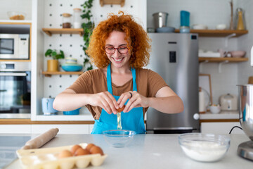 Baking Concept. Portrait Of Joyful Woman Kneading Dough In Kitchen Interior, Cheerful Female In Apron Having Fun While Preparing Homemade Pastry,