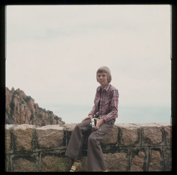 boy sitting on wall 