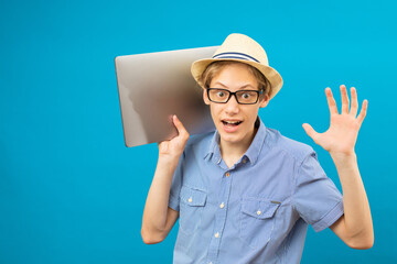 Waist up happy portrait view of the funny businessman teen holding laptop in hands.