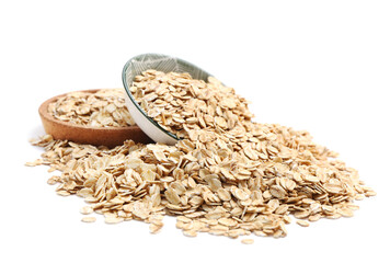 Plate and bowl with raw oatmeal on white background