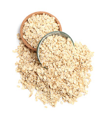 Plate and bowl with raw oatmeal on white background
