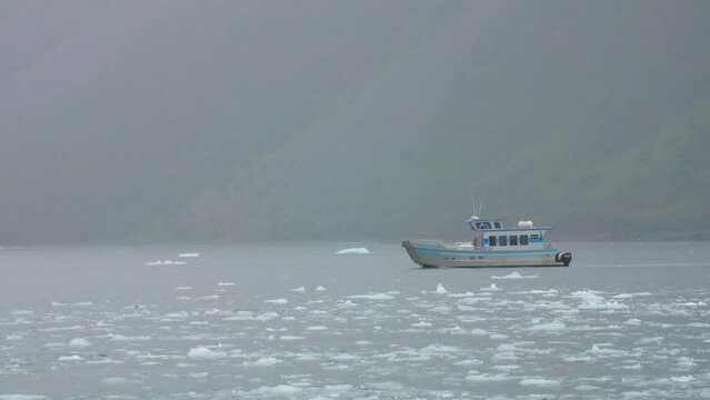 Tour Boat Sailing by Cliffside Alaska