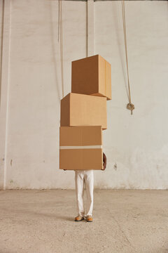 Black man holding boxes in warehouse