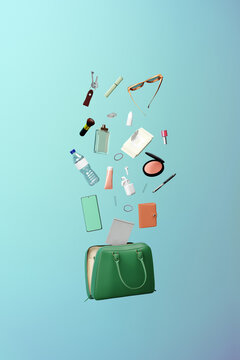 Feminine accessories coming out of a handbag. Purse contents
