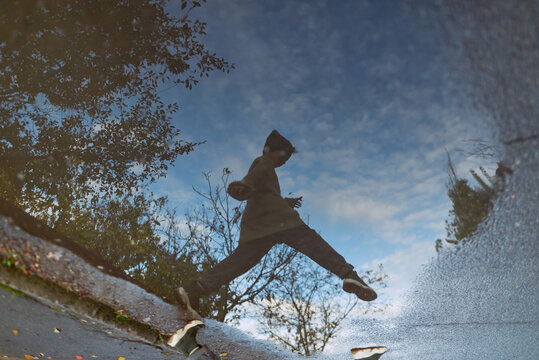 reflection of a boy in a puddle