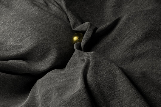 grey wool cloth texture with a golden sphere
