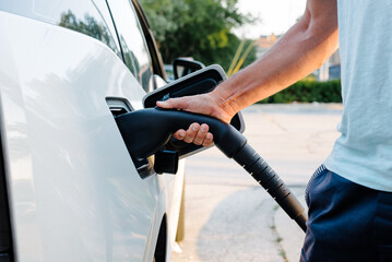 Man plugging EV charger