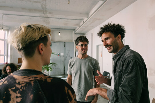 Male Hispanic Therapist Coaching Two Clients
