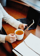 A woman reads messages on a smartphone in the office close-up