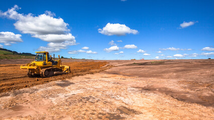 Industrial Earthwork Construction Machine Bulldozer Breaking Ground Earth Soil on Farm Field in Rural Countryside  for Economy Expansion.