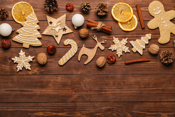 Composition with tasty Christmas cookies, spices and decorations on wooden background