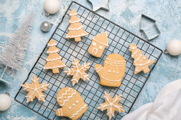 Grid with tasty Christmas cookies and decorations on color background