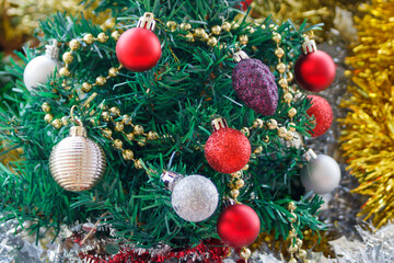 Close-up of decorations on artificial Christmas tree 