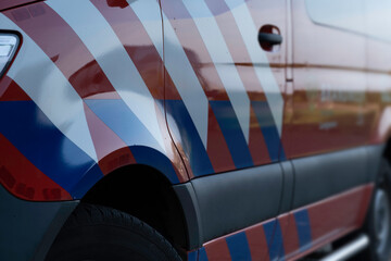 Standard colors (white with blue and red stripes) of a Dutch fire truck or van seen from the side....