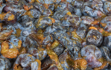A lot of plums with pits removed texture - in the process of cooking plum jam concept