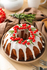 Delicious Christmas cake with cranberry on wooden table, closeup