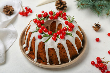 Tasty Christmas cake with cranberry on light background