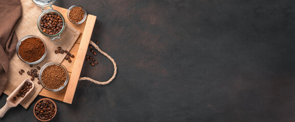 Different types of coffee on a brown background. Top view, copy space.