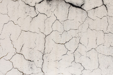 Cracked plaster on the wall of the house.