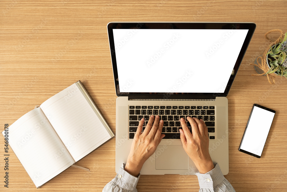 Wall mural laptop computer with blank white desktop screen on the desk with clipping paths. top view