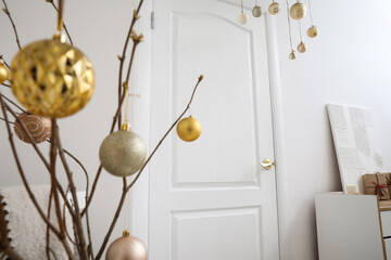 Christmas balls hanging near white door in room