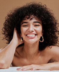 Skincare, hair and natural portrait of black woman happy with beauty, smile and freckles on face. Health, wellness and curly model for hair care or facial cosmetics campaign in brown studio.